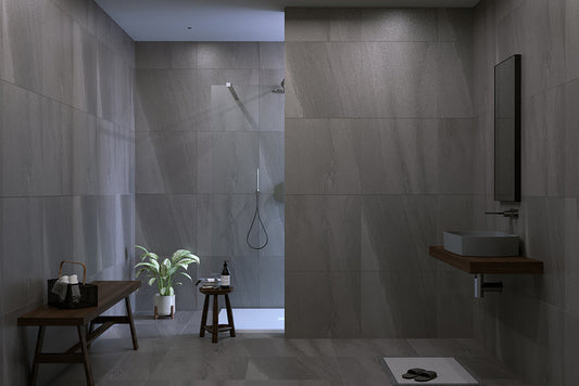 Modern bathroom with gray tiles, a shower, and minimal decor.